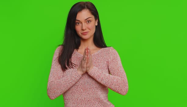 Please, God, forgive me. Young woman sincerely praying to God and looking up with pleading expression, begging apology, beseeching with hopeful face. Millennial girl isolated on chroma key background