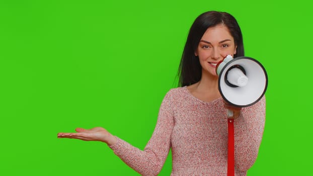 Woman talking with megaphone, proclaiming news, loudly announcing advertisement, warning using loudspeaker to shout speech, pointing empty place. Copy-space promo. Young girl on chroma key background
