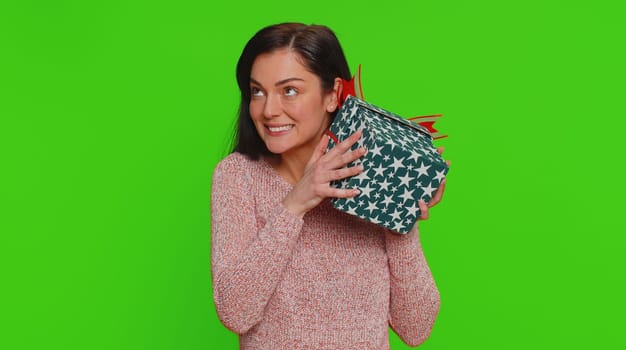 Happy pretty woman opening gift box, unwrapping birthday surprise and expressing great happiness amazement, satisfied with best present bonus. Young adult lovely girl isolated on chroma key background