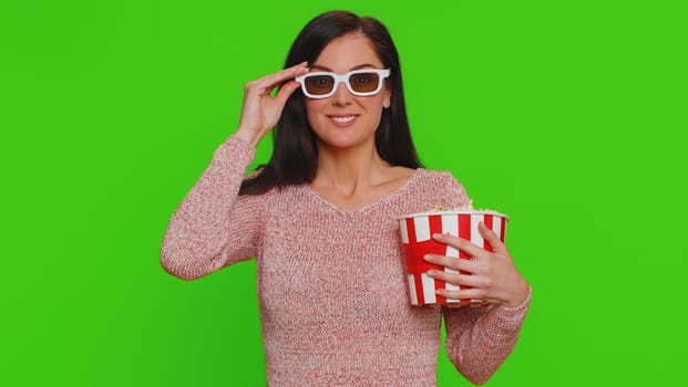 Excited woman in 3D glasses eating popcorn and watching interesting TV home serial, sport game, film, online social media movie content. Girl enjoying domestic entertainment on chroma key background