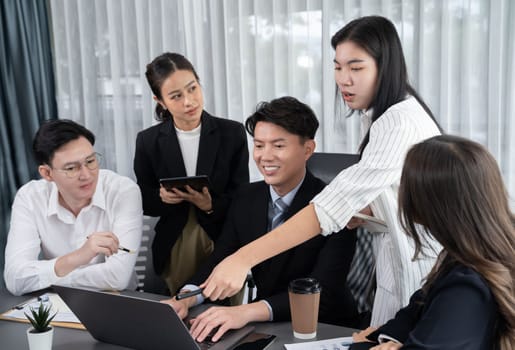 Harmony in office concept as business people analyzing dashboard paper together in workplace. Young colleagues give ideas at manager desk for discussion or strategy planning about project.