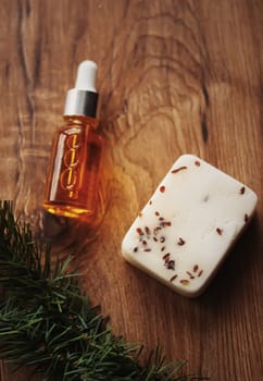 Oil serum bottle and natural herbal handmade soap, beauty and skincare product.