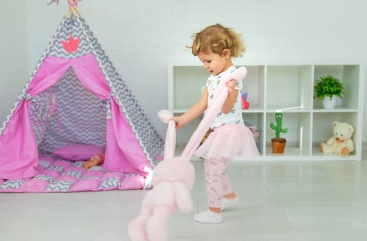 The child plays with toys in the room. Selective focus. Kid.