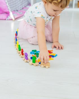 A child plays with a train made of numbers. Selective focus. Kid.