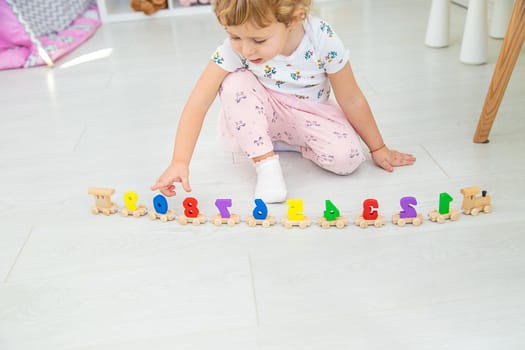 A child plays with a train made of numbers. Selective focus. Kid.