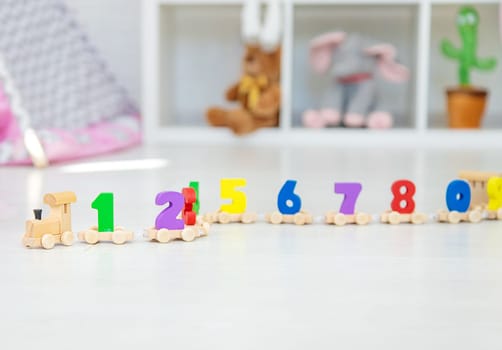 A child plays with a train made of numbers. Selective focus. Kid.