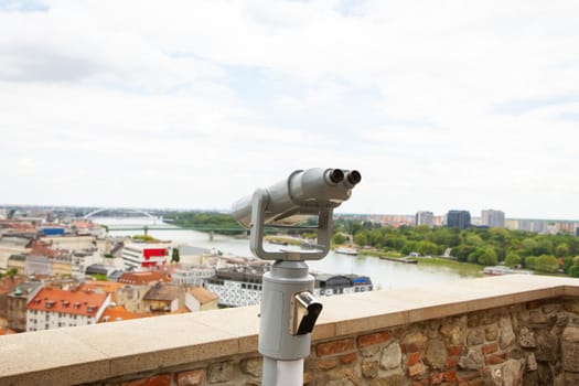 Viewing binoculars. Bratislava, Slovakia, panoramic view with castle on the old and new city. Travel, vacation, walking around the city