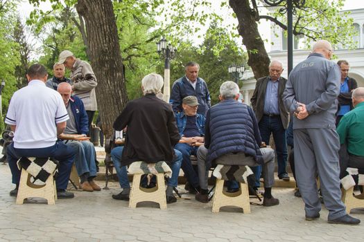 KISLOVODSK, RUSSIA - MAY 06, 2017:Caucasian men play backgammon on the street in a park