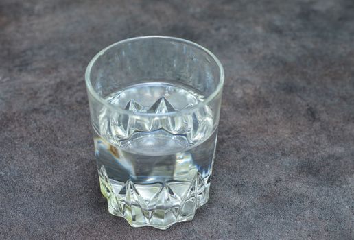 closeup of glass of water on a black table