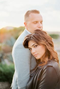 Bride hugged groom and leaned her head on his shoulder. High quality photo