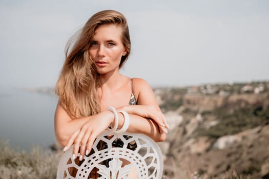 Happy woman portrait in cafe. Boho chic fashion style. Outdoor photo of young happy woman with long hair, sunny weather outdoors sitting in modern cafe