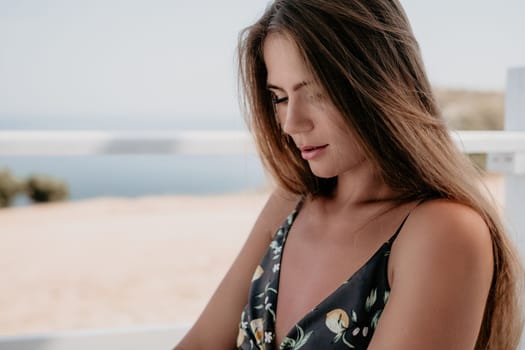 Happy woman portrait in cafe. Boho chic fashion style. Outdoor photo of young happy woman with long hair, sunny weather outdoors sitting in modern cafe