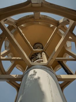 Bangkok, Thailand - 09 Feb, 2023 - A bottom-up view of columnar structures old water tower made of cement and metal spiral staircase. Large water tank in the water supply system. Selective focus.