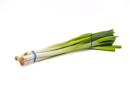 A bunch of organic winter onions as healthy food cropped with high depth of field as studio shot