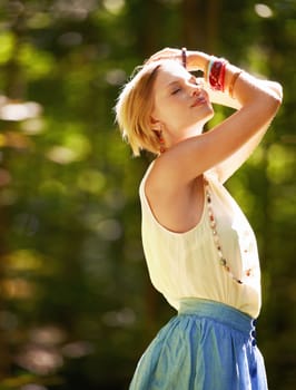 Fascinated by nature. an attractive young woman outdoors on a summer day