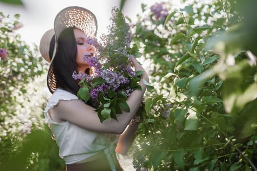 A fashionable girl with dark hair, a spring portrait in lilac tones in summer. Bright professional makeup