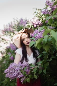 A fashionable girl with dark hair, a spring portrait in lilac tones in summer. Bright professional makeup