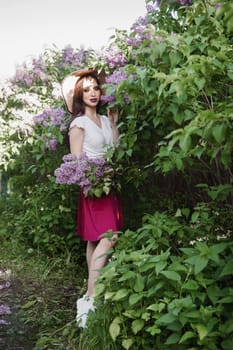 A fashionable girl with dark hair, a spring portrait in lilac tones in summer. Bright professional makeup