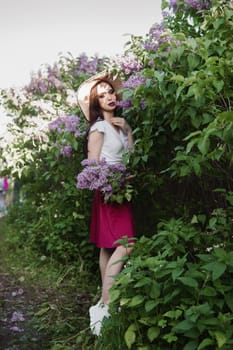 A fashionable girl with dark hair, a spring portrait in lilac tones in summer. Bright professional makeup