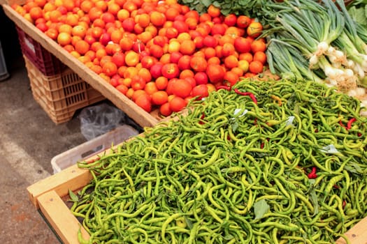 Thin green peppers tomatoes and onions displayed on food market, Kyrenia, Nortern Cyprus