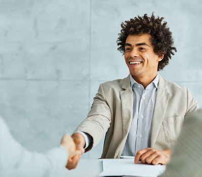 Group of young and senior business people having a meeting and signing a contract agreement and shaking hands handshake in the office. Teamwork and success concept