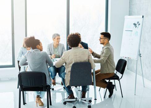 Group of young business people having a meeting or presentation and seminar with whiteboard in the office