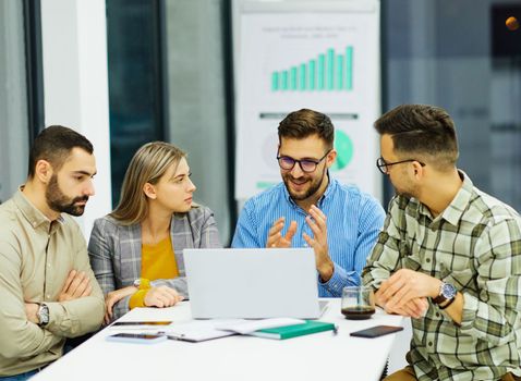 Group of young business people having a meeting or presentation and seminar with whiteboard in the office