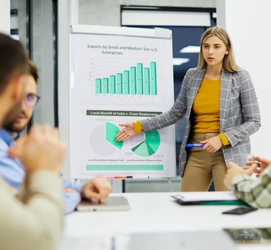 Group of young business people having a meeting or presentation and seminar with whiteboard in the office. Portrait of a young business woman