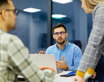 Group of young business people having a meeting or presentation and seminar in the office. Portrait of a young businessman talking