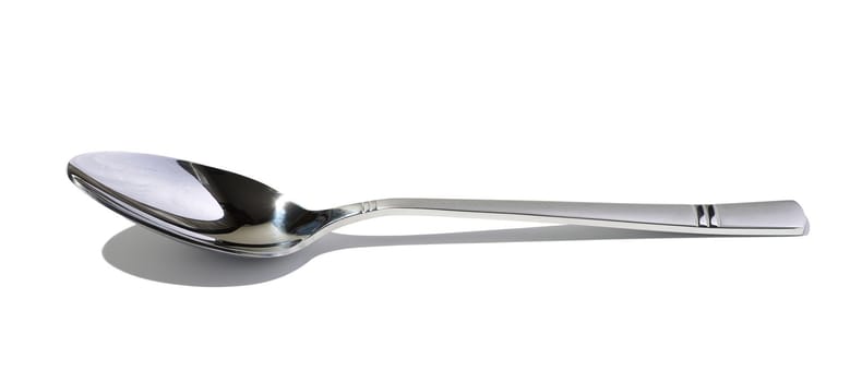 Metal spoon for soup on a white isolated background, close up