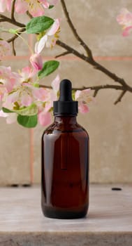 A brown glass bottle with a pipette on the table, a container for cosmetics, aroma oils. Advertising and promotion of products, branding