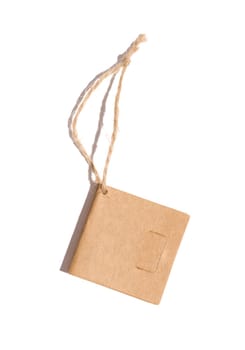 Brown paper square paper tag with a rope on a white isolated background