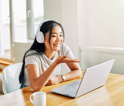 Portrait of a young beautiful woman having video call on laptop at home