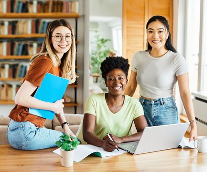 Portrait of a young happy girls using laptop at home or in the office