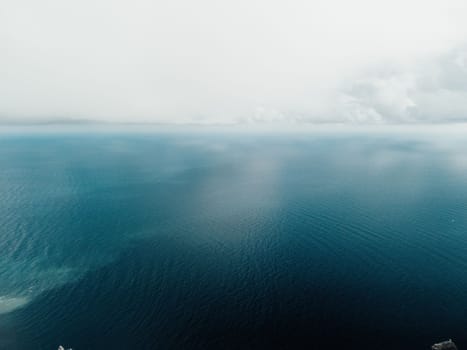 Abstract nature summer or spring ocean sea background. Small waves on water surface in motion blur with bokeh lights from sunrise.