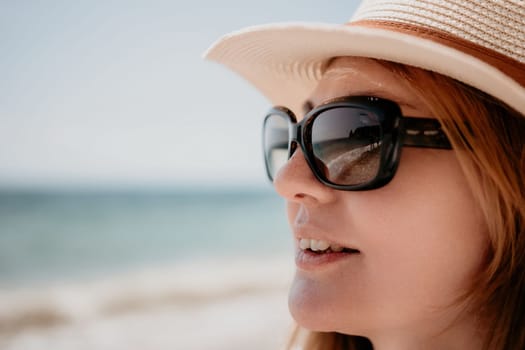 Young woman in red bikini on Beach. Blonde in sunglasses on pebble beach enjoying sun. Happy lady in one piece red swimsuit relaxing and sunbathing by turquoise sea ocean on hot summer day. Close up,
