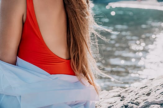 Sexy young woman in stylish bikini lying on seashore, closeup. Holiday, vacation and recreational concept.