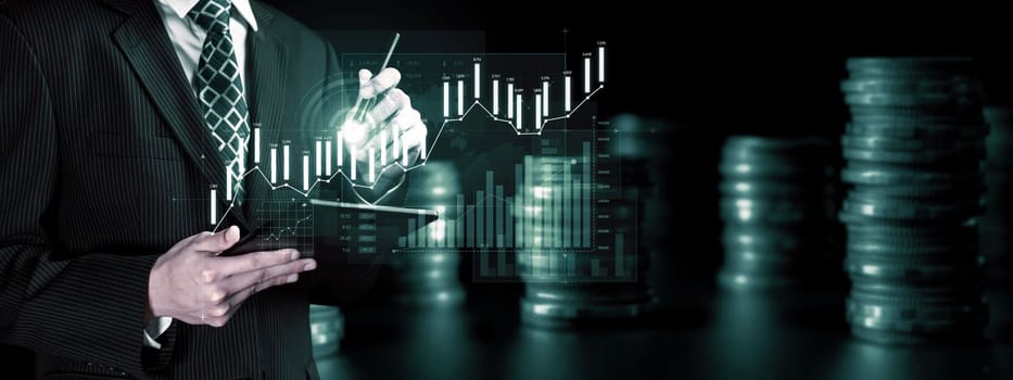 Businessman analyst working with digital finance business data graph showing technology of investment strategy for perceptive financial business decision. Digital economic analysis technology concept.