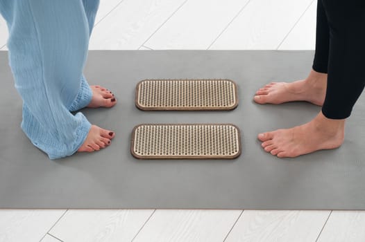 Female feet next to sadhu boards in yoga studio