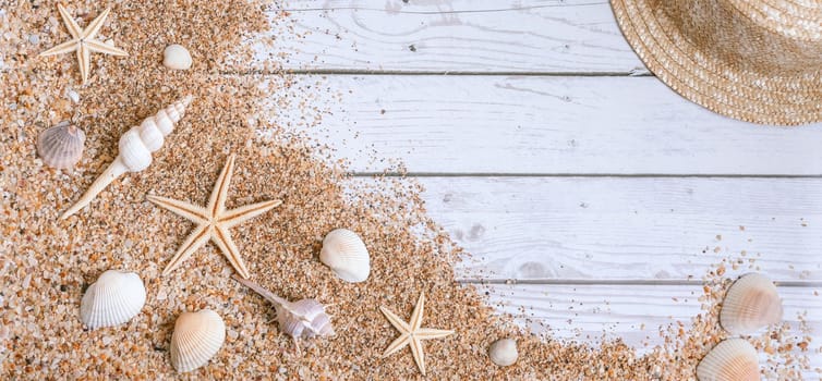 Sand seashells baner background. Summer time concept with sea shells and starfish on wooden background and sand.