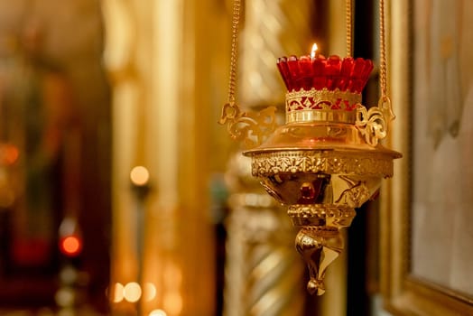Orthodox Church. Christianity. Festive interior decoration with burning candles and icon in traditional Orthodox Church on Easter Eve or Christmas. Religion faith pray symbol