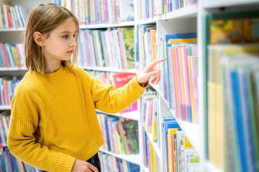 Schoolgirl choosing book in school library. Smart girl selecting literature for reading. Books on shelves in bookstore. Learning from books. School education. Benefits of everyday reading