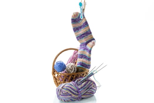 Colored threads, knitting needles and other items for hand knitting, isolated on a white background.