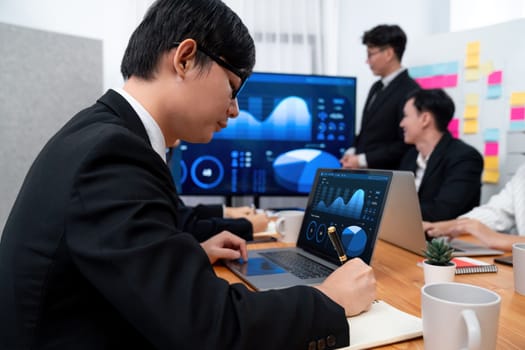 Confidence and asian businessman give presentation on financial analyzed by business intelligence in dashboard report to other people in board room meeting to promote harmony in workplace.