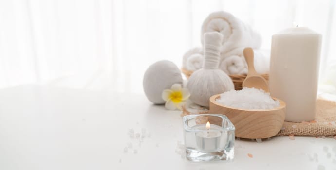 Spa accessory composition set in day spa hotel , beauty wellness center . Spa product are placed in luxury spa resort room , ready for massage therapy from professional service .