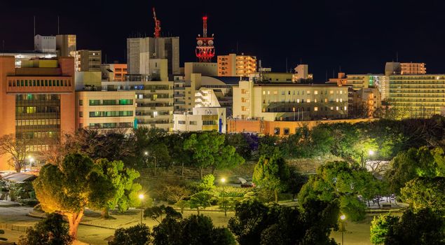 Lights from mid-rise offices and apartment buildings in small city at night. High quality photo