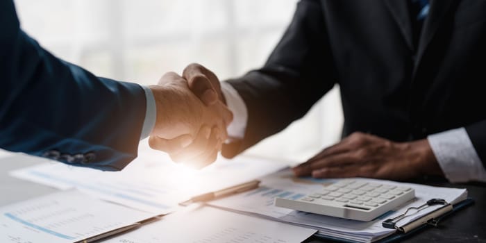 Business handshake for teamwork of business merger and acquisition,successful negotiate,hand shake,two businessman shake hand with partner to celebration partnership and business deal concept...