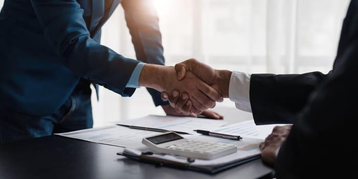 Business handshake for teamwork of business merger and acquisition,successful negotiate,hand shake,two businessman shake hand with partner to celebration partnership and business deal concept...