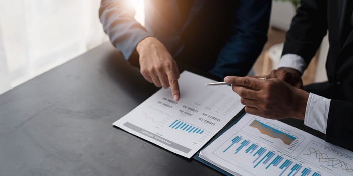 Business People Meeting using laptop computer,calculator,notebook,stock market chart paper for analysis Plans to improve quality next month. Conference Discussion Corporate Concept....