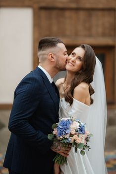 the first meeting of the bride and groom in wedding outfits in the park